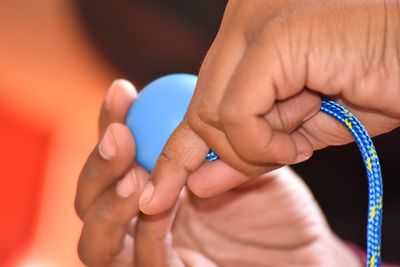 Cropped hands of person holding cable