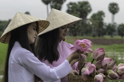 Close-up of woman with pink flowers