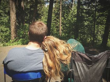 Rear view of couple walking in forest