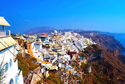 High angle view of town against blue sky