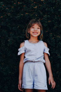 Portrait of a smiling girl standing outdoors