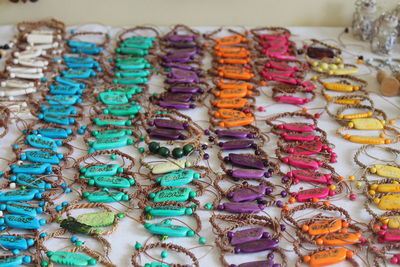 High angle view of multi colored bracelets for sale on table