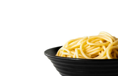 Close-up of noodles in bowl against white background