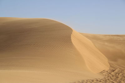 Scenic view of desert against clear sky