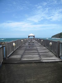 Scenic view of pier against cloudy sky