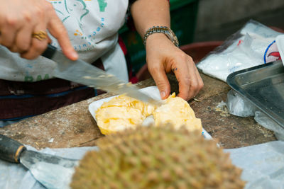 Midsection of man preparing food at market