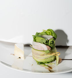 Close-up of bread in plate against white background