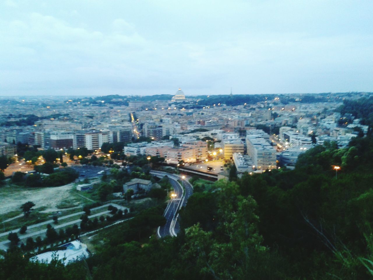 building exterior, cityscape, architecture, city, built structure, crowded, high angle view, sky, residential district, tree, city life, residential building, capital cities, aerial view, travel destinations, tower, skyscraper, residential structure, river, tall - high