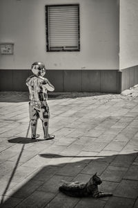 Full length of boy standing against building