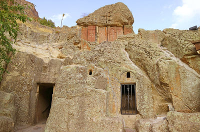 Medieval khachkars armenian cross-stone inset in mountain rock, geghard medieval monastery armenia