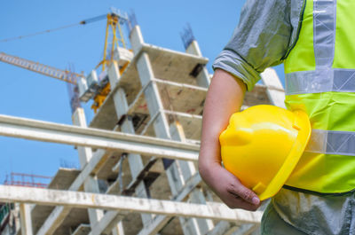 Low angle view of man working at construction site