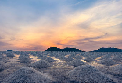 Salt farm in the morning with sunrise sky over the mountain. organic sea salt. 