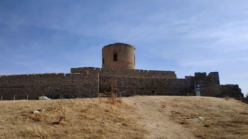 Low angle view of old ruin building against sky