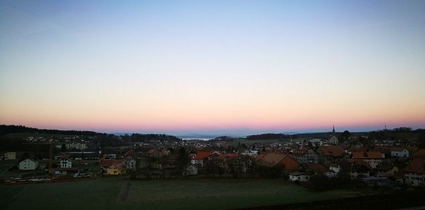 High angle view of illuminated city against clear sky