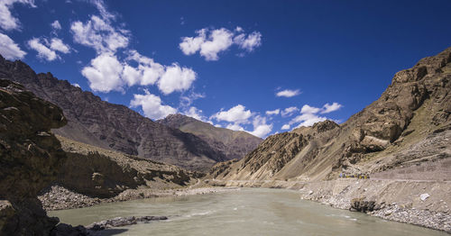 Scenic view of mountains against blue sky