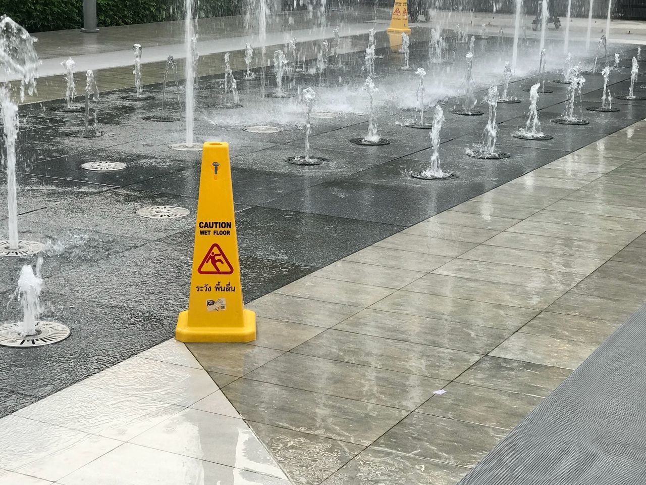 ARROW SIGN ON WET ROAD IN CITY