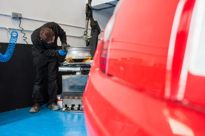 Male mechanic repairing machinery in workshop