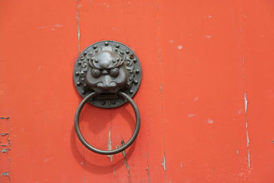 Knocker on orange door