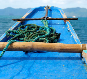 Close-up of rope tied on bollard against sea