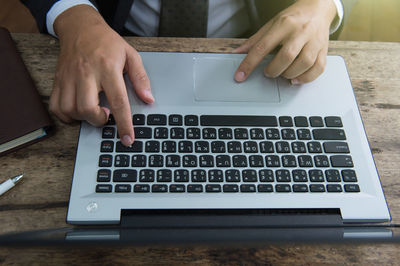 Low section of person using laptop on table
