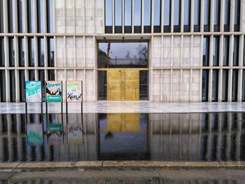 Reflection of building on wet glass window