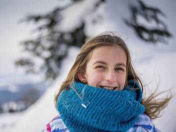 Girl in warm clothes enjoying on snow 