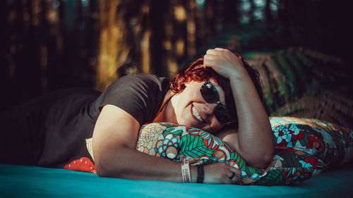 Portrait of woman lying on bed