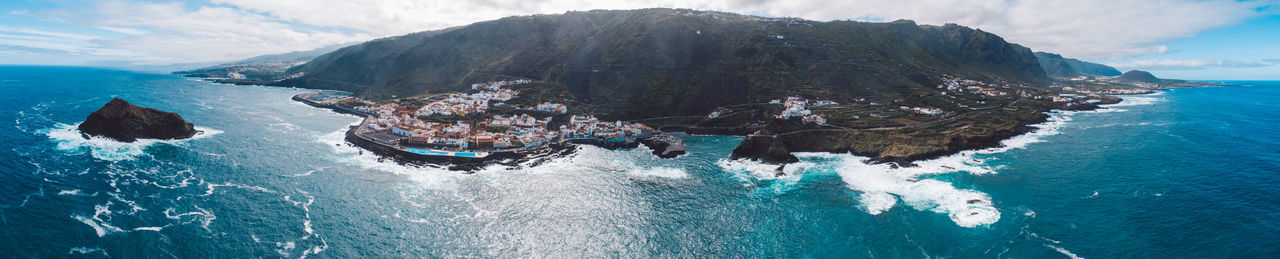 Panoramic view of sea against mountains