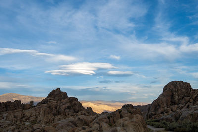 Rock formations on landscape against sky