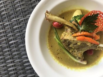 High angle view of lamb chops in bowl on table