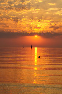 Scenic view of sea against orange sky