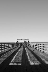 Pier over sea against clear sky