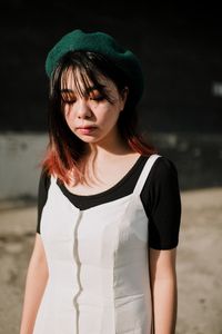 Portrait of a beautiful young woman standing outdoors