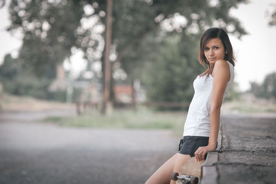 Portrait of smiling young woman in park