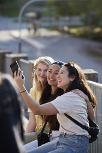 Group of young female friends taking selfie outdoors