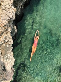 High angle view of woman swimming in sea