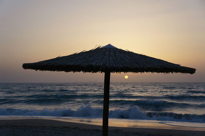 Scenic view of sea against clear sky during sunset