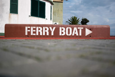 Surface level of ferry boat text on footpath