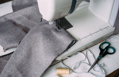 Sewing machine, accessories and fabric. cozy creative sewing process at home