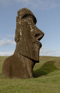 Stone structure on field against sky