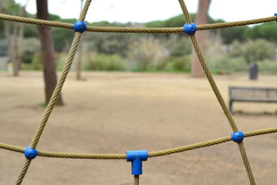 Close-up of swing against blue sky