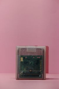 Close-up of old electric light against pink background
