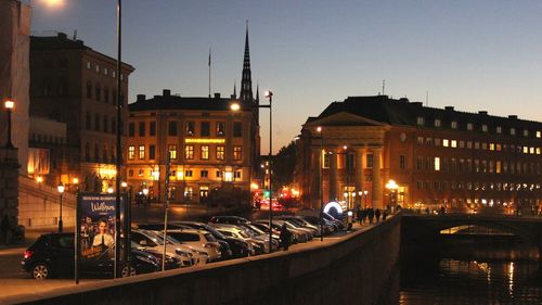 Illuminated city against sky at night