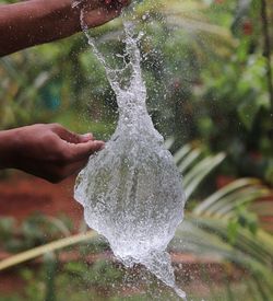 Close-up of hand splashing water