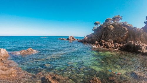 Scenic view of sea against clear blue sky