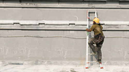 Man working on wall