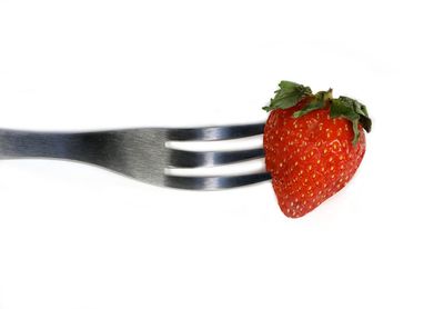 High angle view of strawberries on table against white background