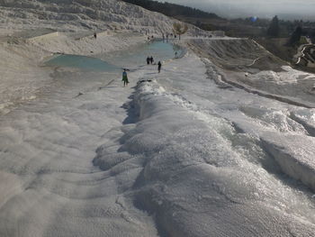 High angle view of people on snow covered mountain