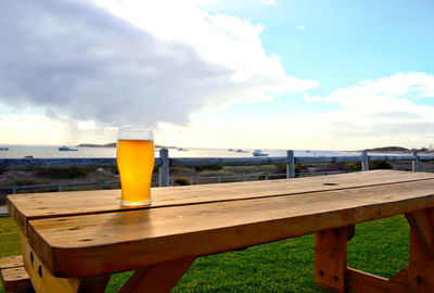 View of beer glass on table against sky