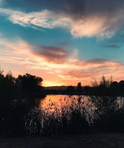 Scenic view of lake against sky during sunset